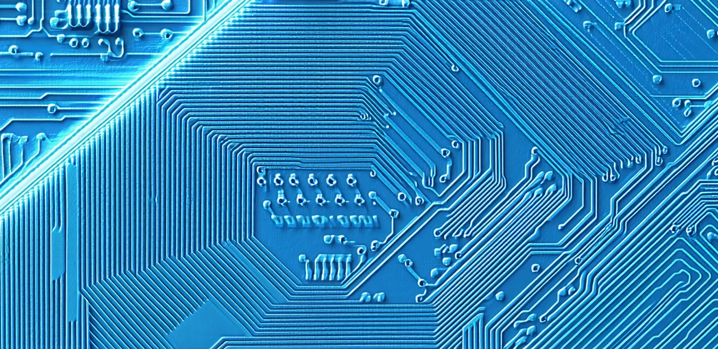 Close-up view of semiconductor wafer surface showing microscopy-level detail of wafer die pattern under inspection lighting